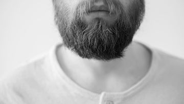 a man showcasing his stringy beard