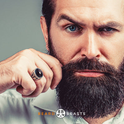 bearded man wondering if he should use beard oil or balm first