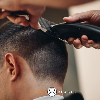 a man getting a buzz cut in a barber shop
