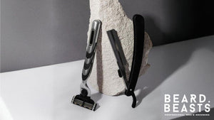 Side-by-side image of a multi blade razor and a single blade razor against a textured stone backdrop, illustrating the design differences in the single blade razor vs multi blade razor debate.