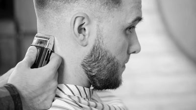 Barber carefully crafting a skin fade haircut for a modern look, showcasing the difference between skin fade vs mid fade styles