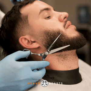 Our featured image which showcases a man with a 1 inch beard getting his beard trimmed