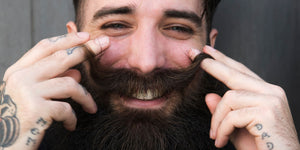 Smiling bearded man demonstrating proper beard grooming after avoiding common beard grooming mistakes