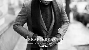 Stylish man showcasing men's winter fashion with a herringbone coat and layered sweaters - Men's Fashion Tips For Beginners