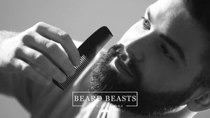 Focused man carefully combing his beard to avoid beard grooming mistakes, with Beard Beasts Men's Grooming logo in view