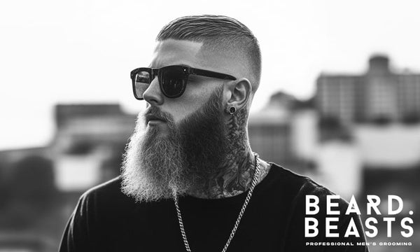 Confident man with a full, styled beard representing the results of following smart beard growth tips.