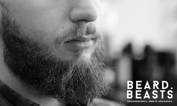 Close-up of a bearded man with visible beard hair sticking out, highlighting the need for proper grooming techniques.