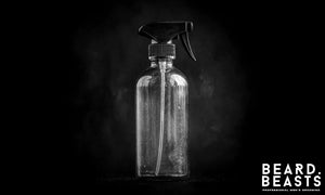 Blue sea salt spray bottle for men on black background representing the best sea salt sprays for men