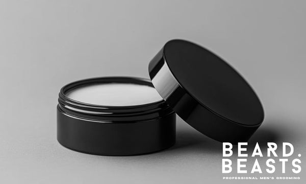 Men’s hair paste in a matte black jar with a soft beige texture, photographed on a clean grey background with a minimalist aesthetic.