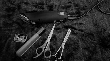 Professional hair clippers, ready for a precise number 5 buzz cut hairstyle.