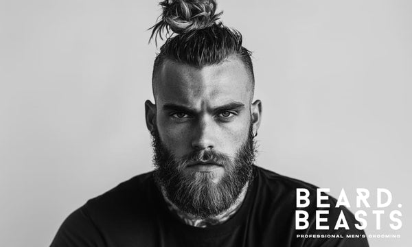 A bold and rugged man with a high fade man bun, featuring a sharp fade and a loosely styled, textured bun.