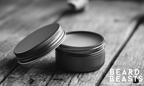 metal tin of homemade beard balm on rustic wooden surface with Beard Beasts logo