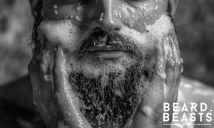 Bearded man washing his beard with lathered cleanser—visual guide for how often you should wash your beard and proper grooming technique.