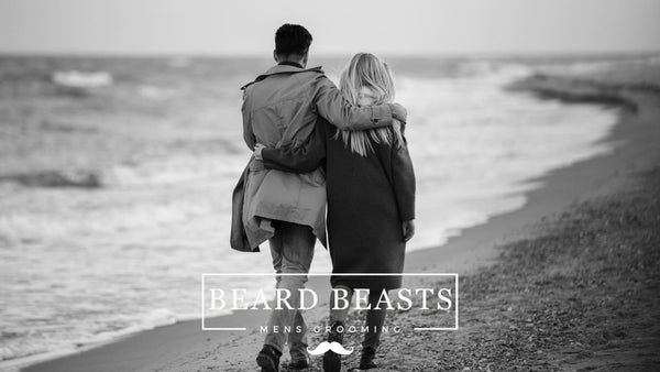 How A Man Should Love A Woman Quotes Featured Article Image of a man and woman walking on the beach.