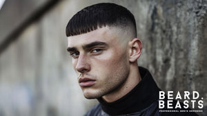 A young man with a high fade fringe haircut, featuring a sharp high fade that blends seamlessly into a structured blunt fringe across the forehead. 
