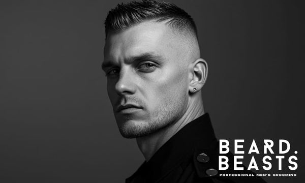 A black and white portrait of a man with a high fade haircut with short hair, styled with a sleek, textured top. 
