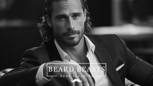 Dapper man with a styled, dry beard in a suit for Beard Beasts men's grooming campaign