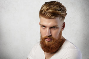 A man with styled thin hair and a red beard, showcasing volume and texture achieved using sea salt spray for fine hair. 