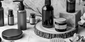 Various men's hair products including hair paste and hair clay displayed on a wooden surface, showcasing different bottles and containers for styling needs.