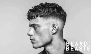 Side profile of a man with a skin fade textured fringe haircut, showcasing defined volume and clean fade details.